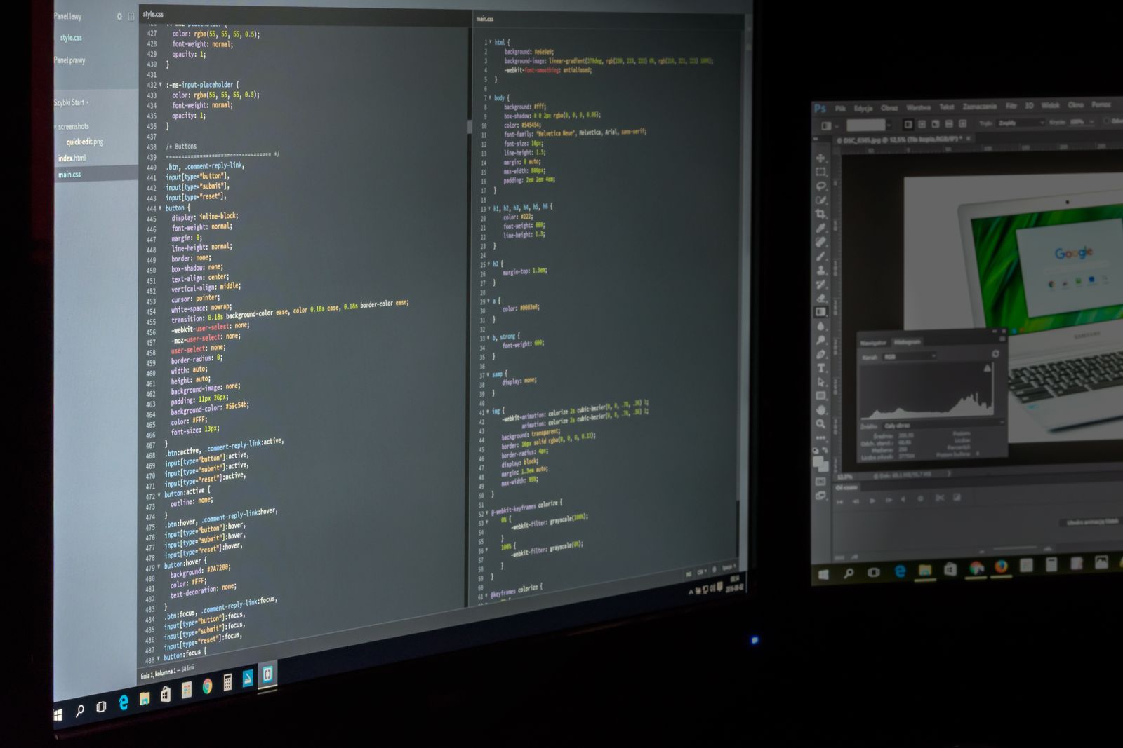 Designer working on website code and layouts across two studio monitors